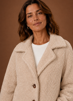 Close-up of the teddy coat texture and buttoned double-breasted front