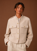 Front view of women's cropped jacket with button-front closure and cropped hem