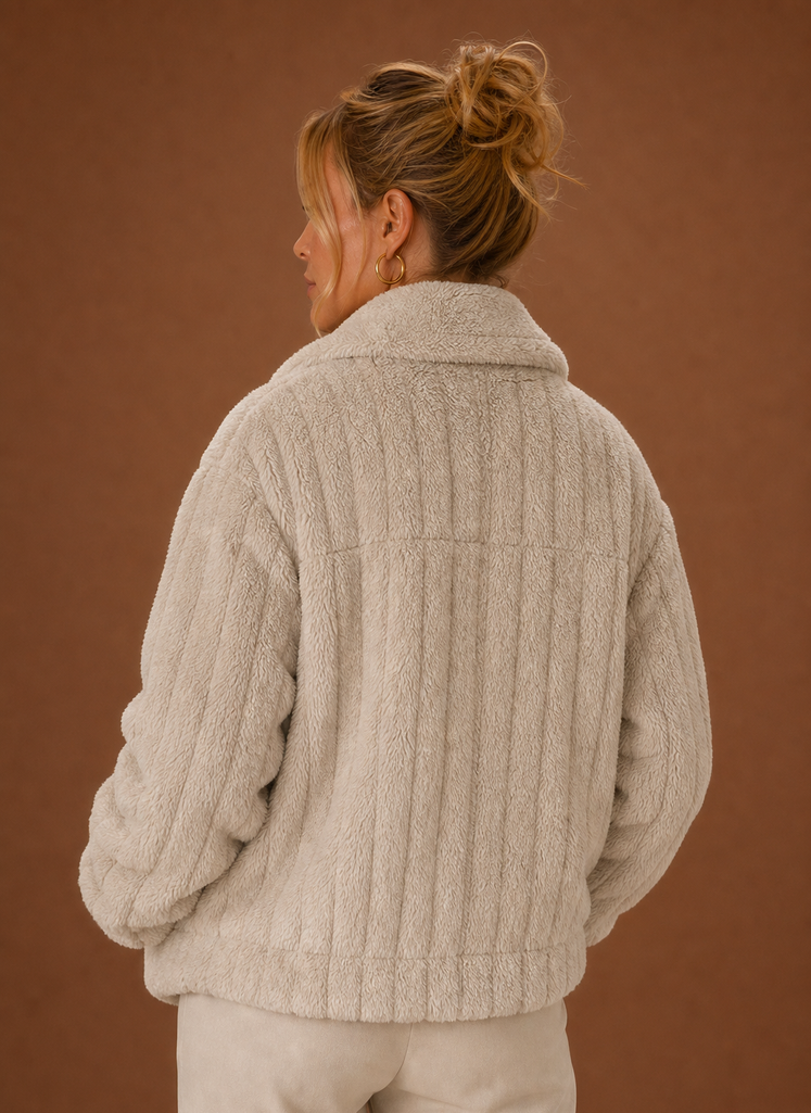Back view of the women's teddy-style winter coat displaying the clean, minimal lines