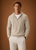 Front view of men's hooded half-zip knit sweater on a mannequin showing the hood and half-zip placket