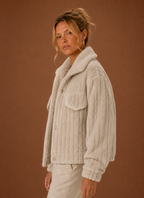 Side profile of the oversized teddy jacket showing relaxed silhouette and sleeve shape