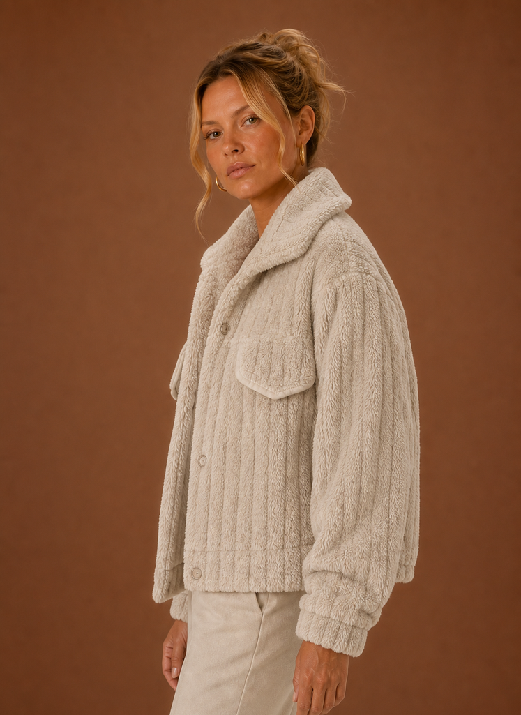 Side profile of the oversized teddy jacket showing relaxed silhouette and sleeve shape