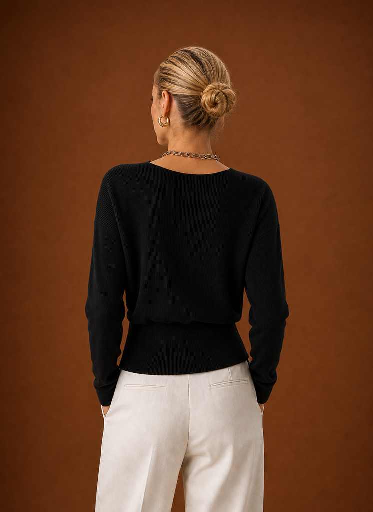 Back view of women's wrap sweater with clean hemline