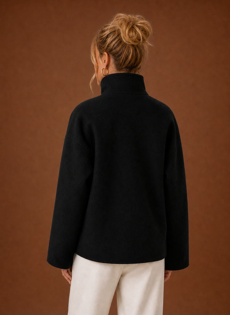 Back view of a women's funnel neck jacket in grey