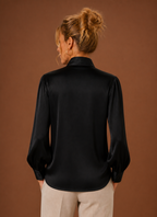 Back view of women's V-neck sweater showing clean finished hem and straight back silhouette