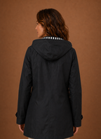 Back view of women's hooded trench coat showing hood and clean back seam