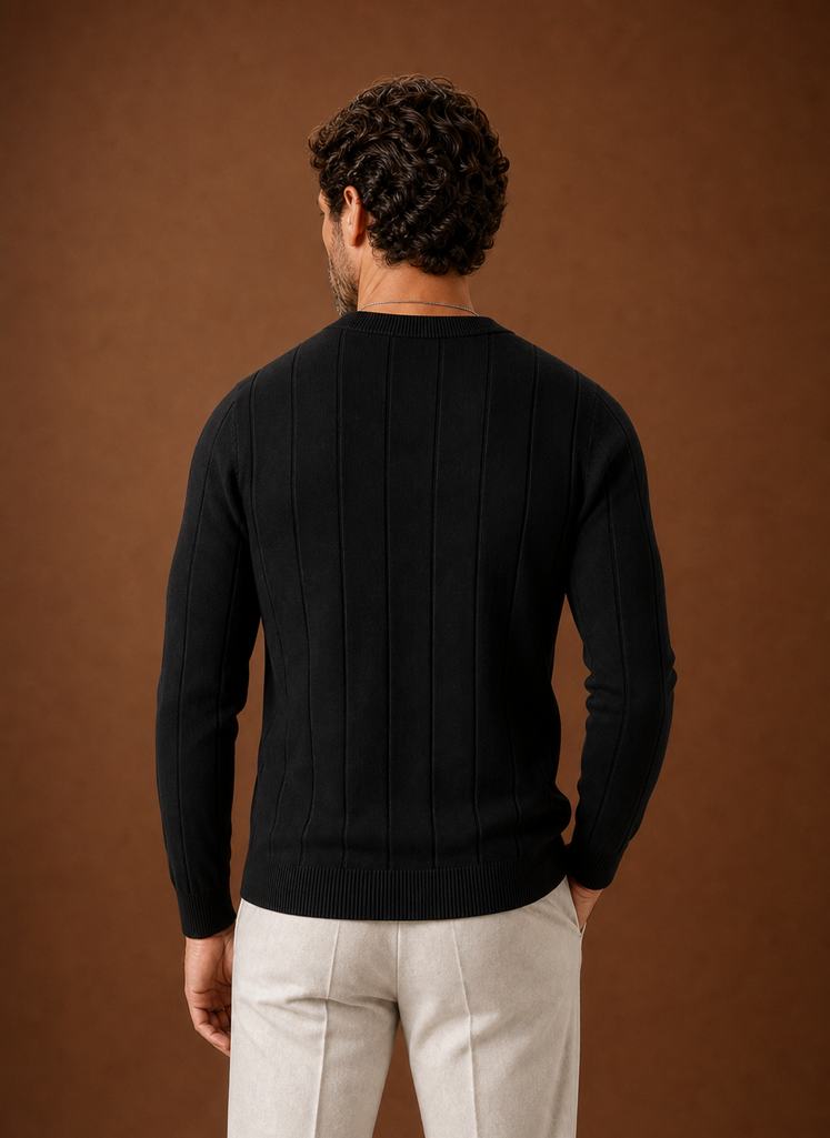 Back view of crew neck sweater in black highlighting ribbed hem