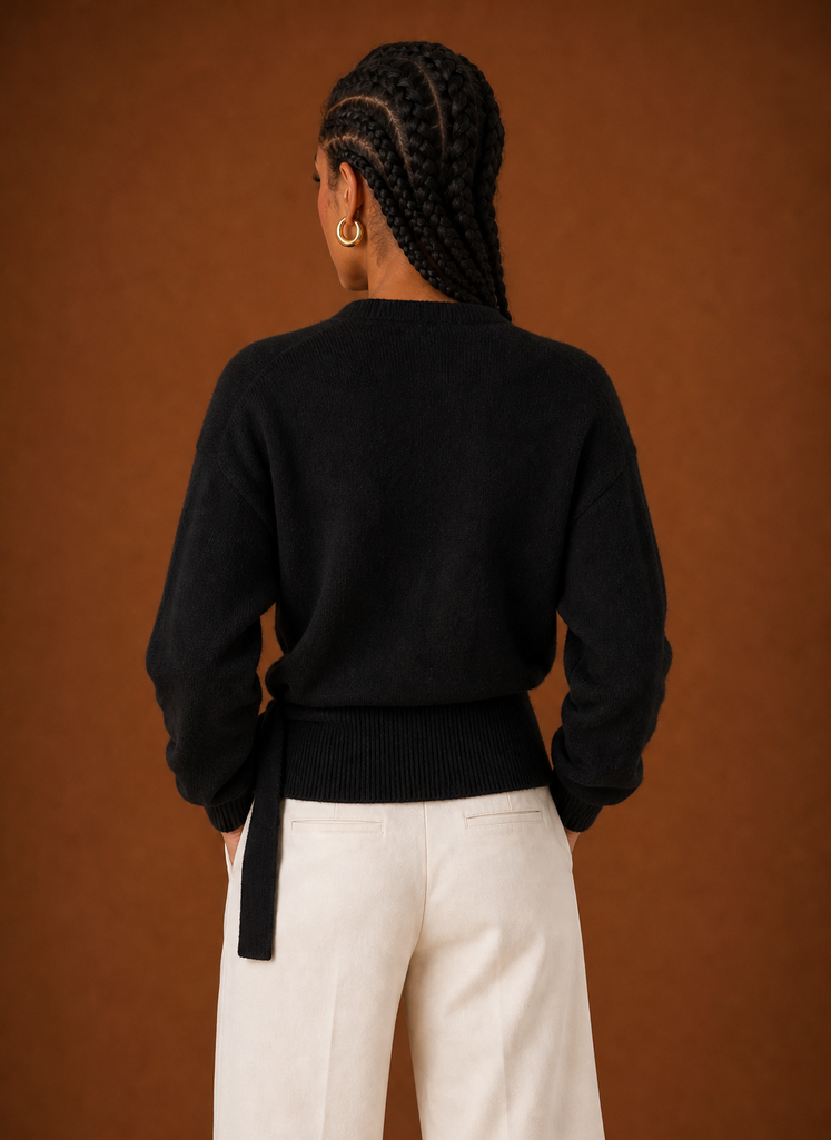 Back view of the sweater showing smooth knit finish and cropped hem