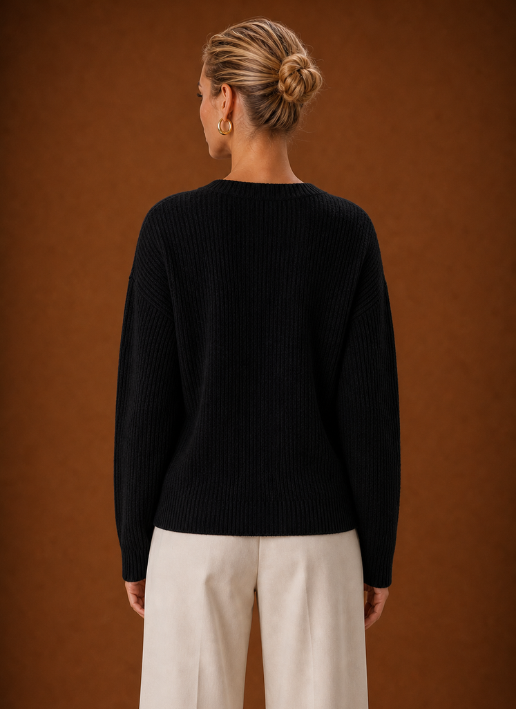 Back view showing ribbed knit back and clean hem of the wrap sweater