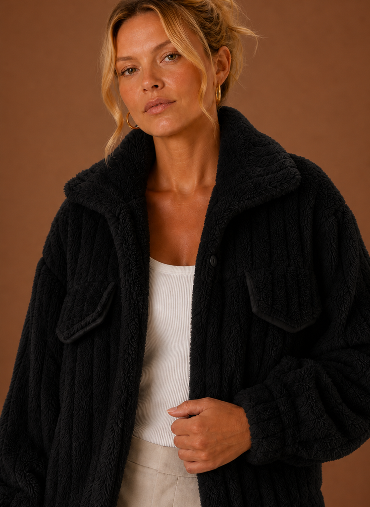 Close-up of the jacket's textured teddy-style exterior and stitched details