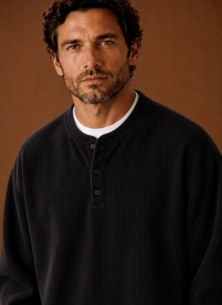 Close-up of ribbed texture and button placket on men's henley shirt