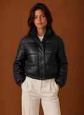 Front view of a women's bomber jacket on a mannequin showing the zip-front silhouette