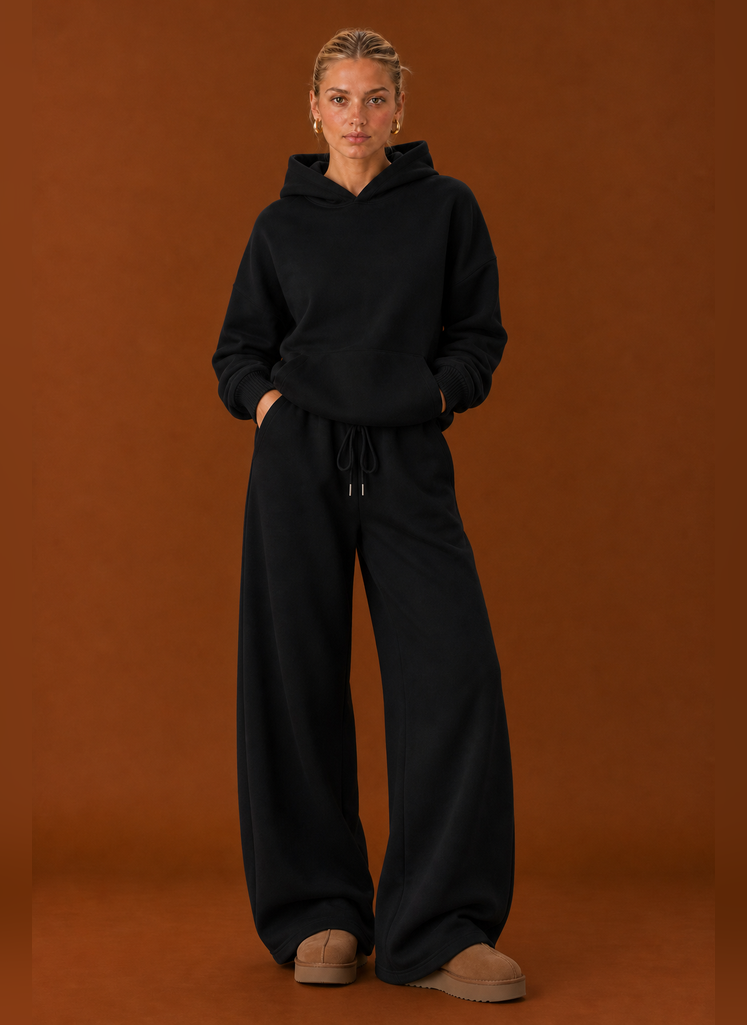 Front view of two-piece sweatsuit set showing sweater and pants on a model