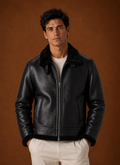 Front view of men's bomber jacket on mannequin with zip-front closure and classic collar