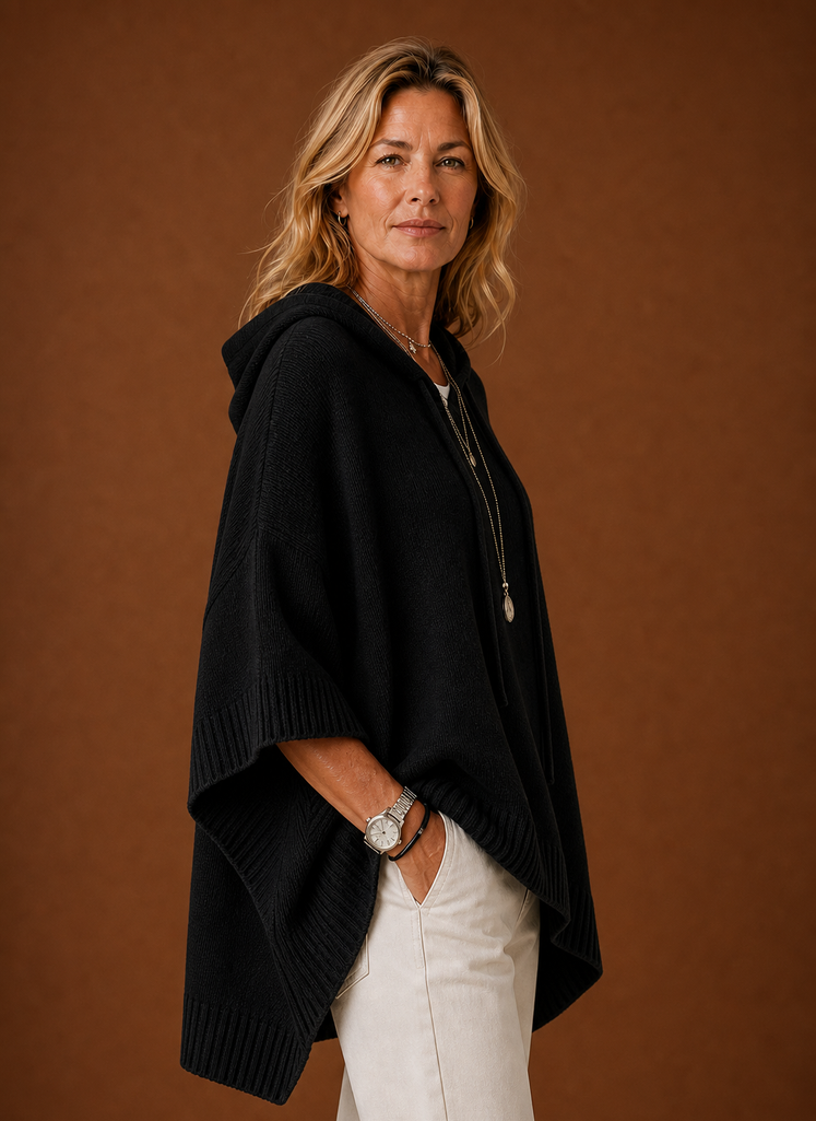 Side profile of hooded pullover highlighting oversized silhouette and sleeve length