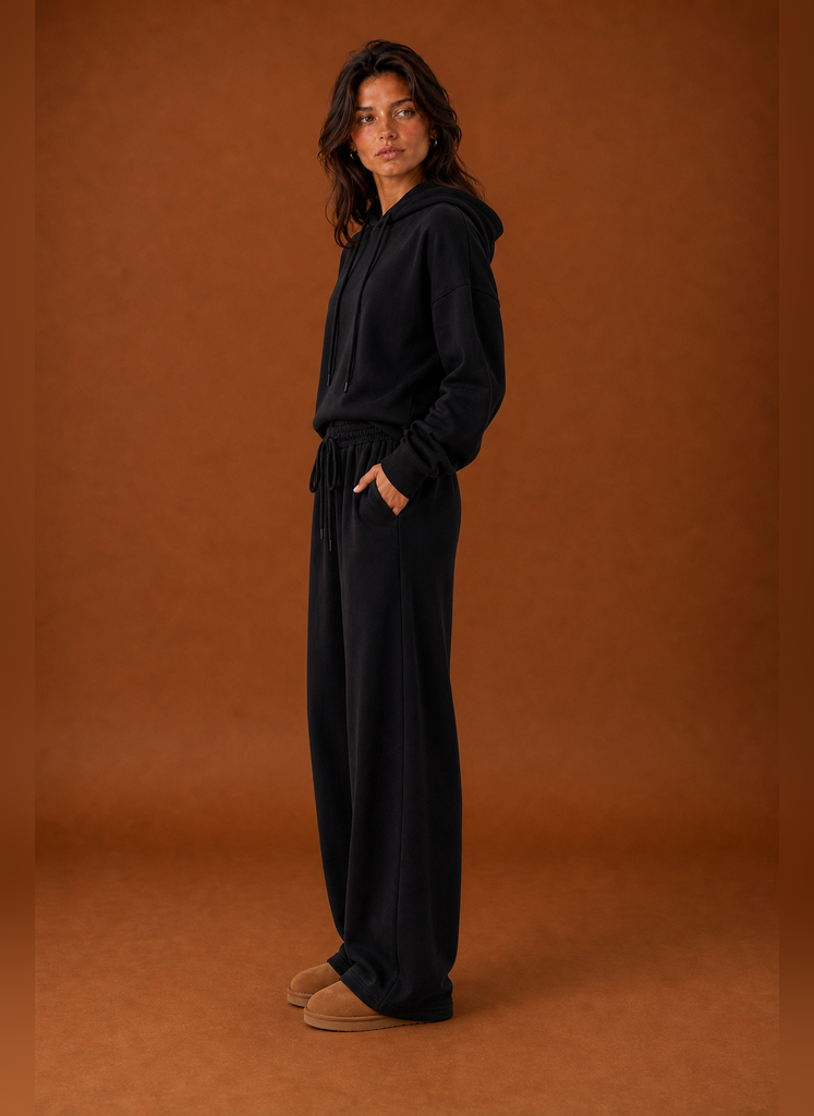 Side view of a women's sweatsuit highlighting the tracksuit silhouette and pant profile