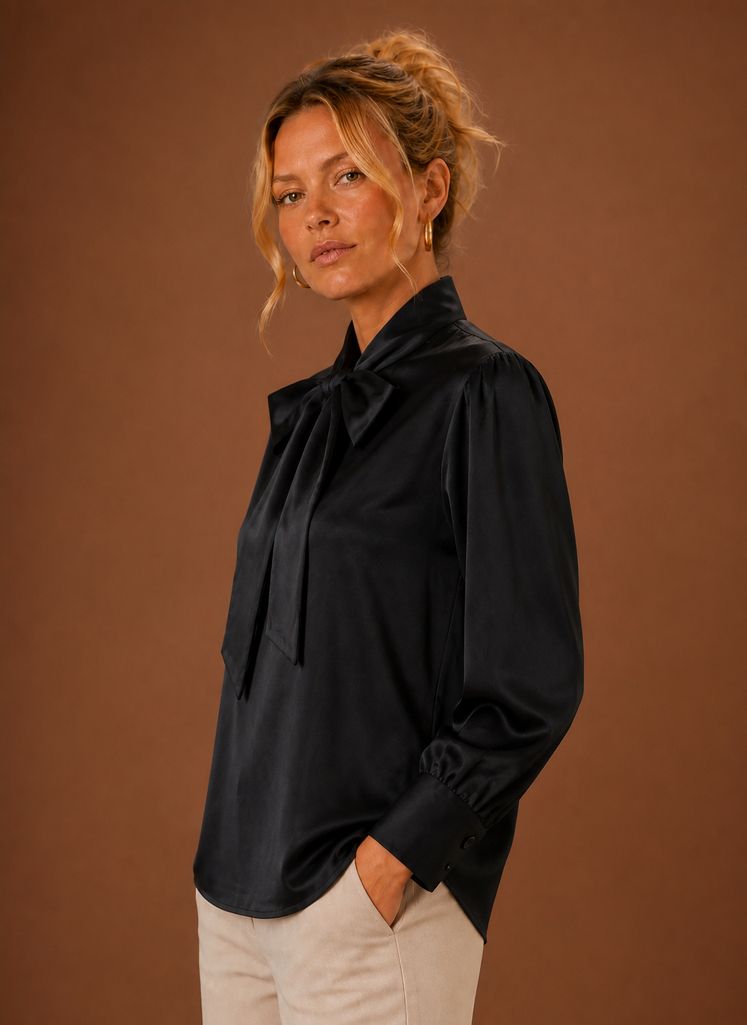 Side view of women's V-neck sweater displaying long sleeve and drape