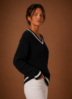 Side view of sweater showing long sleeve silhouette and knit drape