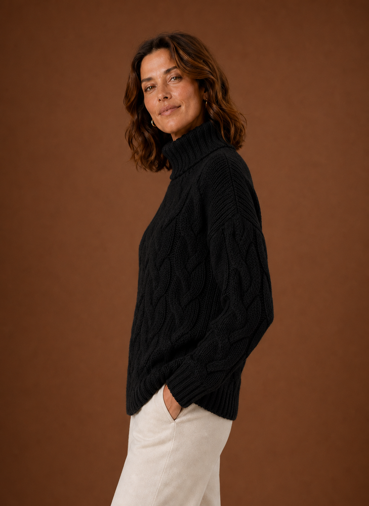 Side profile of Areleon cable knit sweater showing sleeve shape and drape
