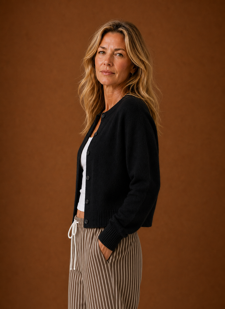 Side view of the women's crew neck cardigan showing the sleeve and button closure