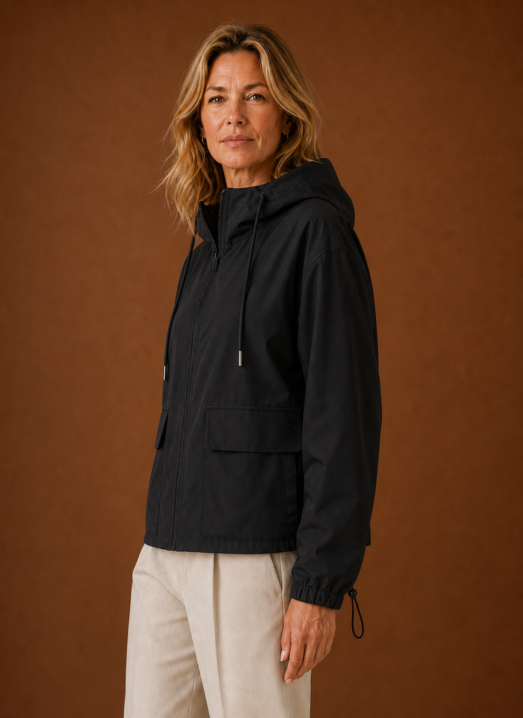 Side profile of women's hooded windbreaker jacket showing silhouette and hood