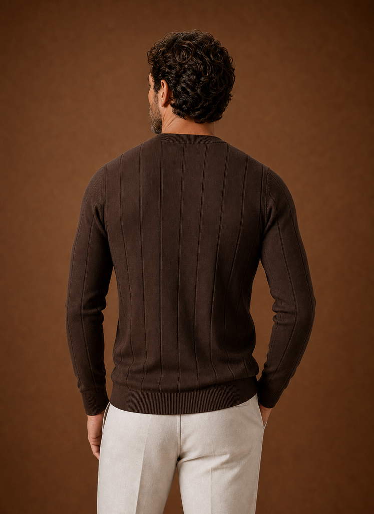 Back view of crew neck sweater in black highlighting ribbed hem