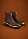 Front view of women's ankle boot showing front zipper and ankle-height silhouette