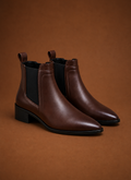 Front view of women's pointed-toe Chelsea ankle boot showing slim toe and front profile