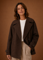 Front view of women's long, loose coat with button-front closure