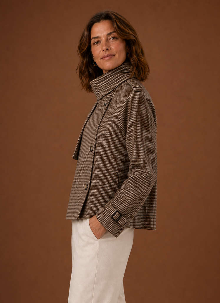 Side view showing the cropped silhouette and funnel neckline of the jacket