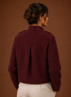 Back view of the cropped button-front coat highlighting the hemline