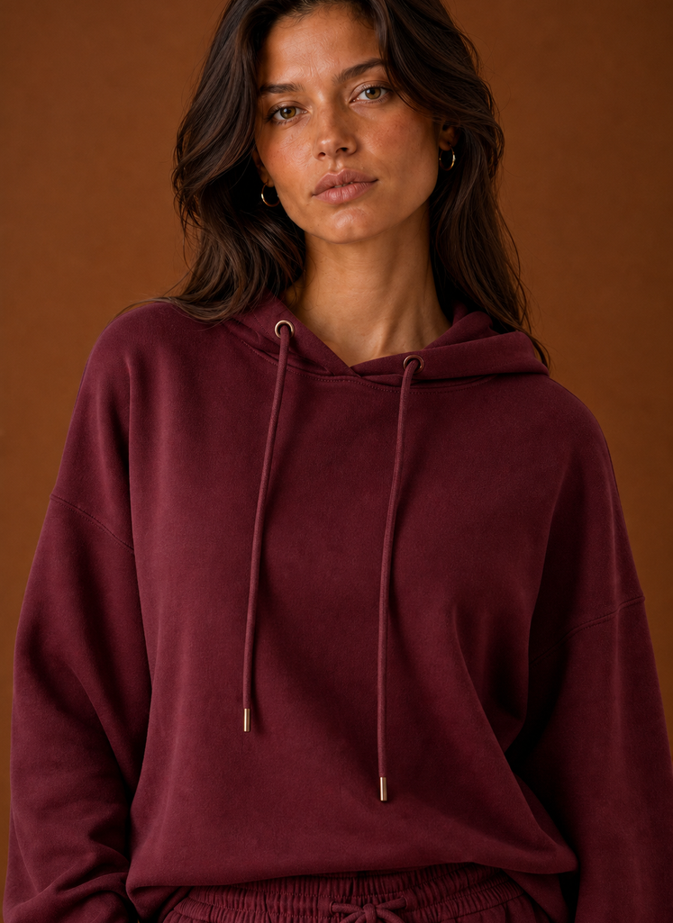 Close-up of the sweatsuit fabric and stitch detailing on the sweatshirt and pant waistband area