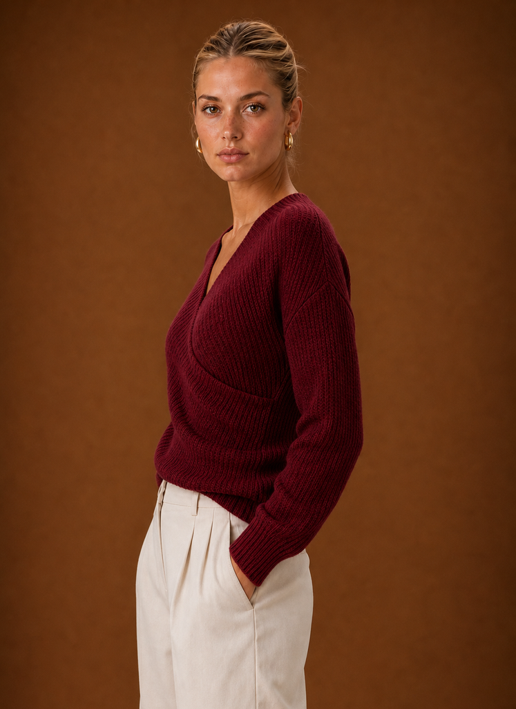 Side view highlighting ruched side detailing and the sweater's fitted silhouette
