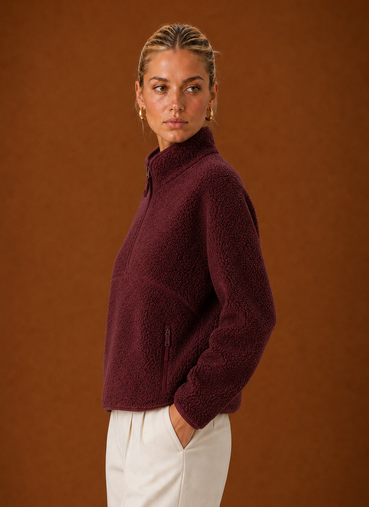 Side profile of the pullover highlighting the silhouette and quarter-zip neckline