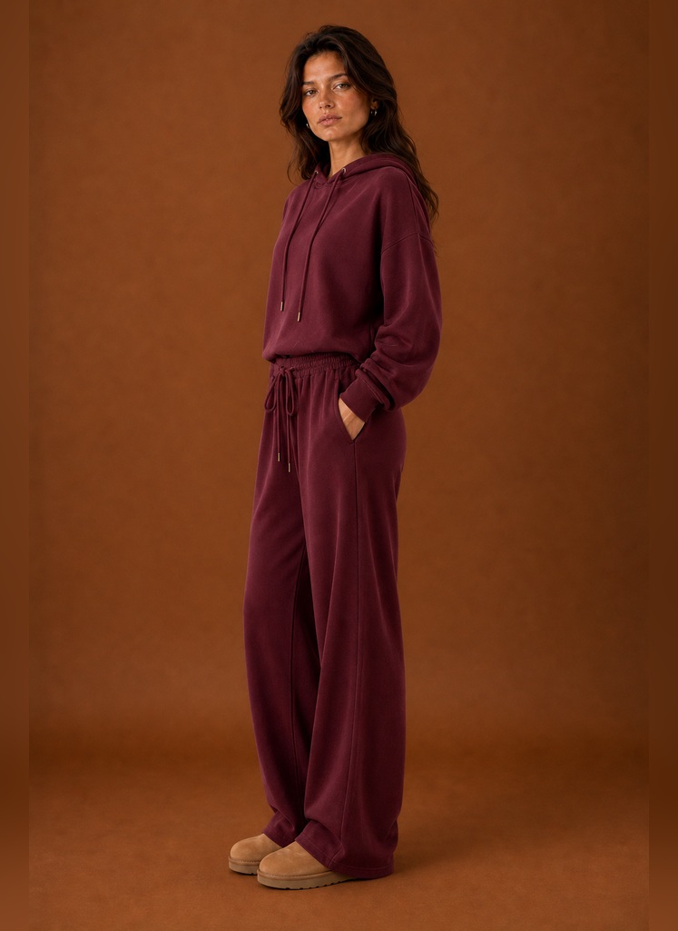 Side view of a women's sweatsuit highlighting the tracksuit silhouette and pant profile