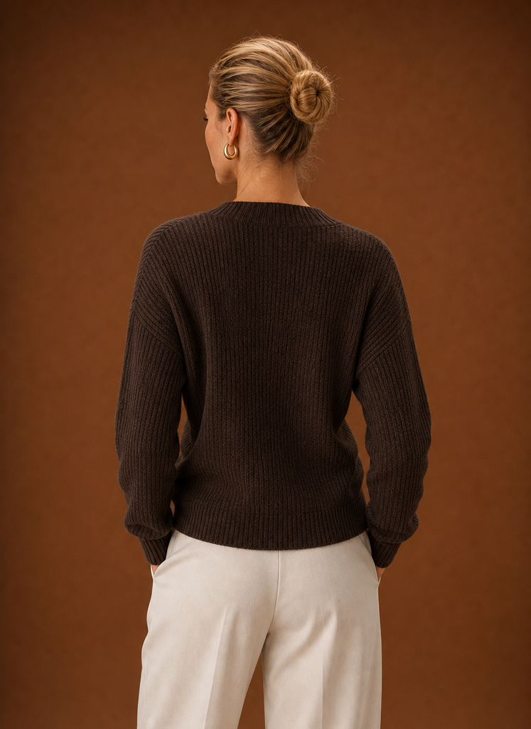 Back view showing ribbed knit back and clean hem of the wrap sweater