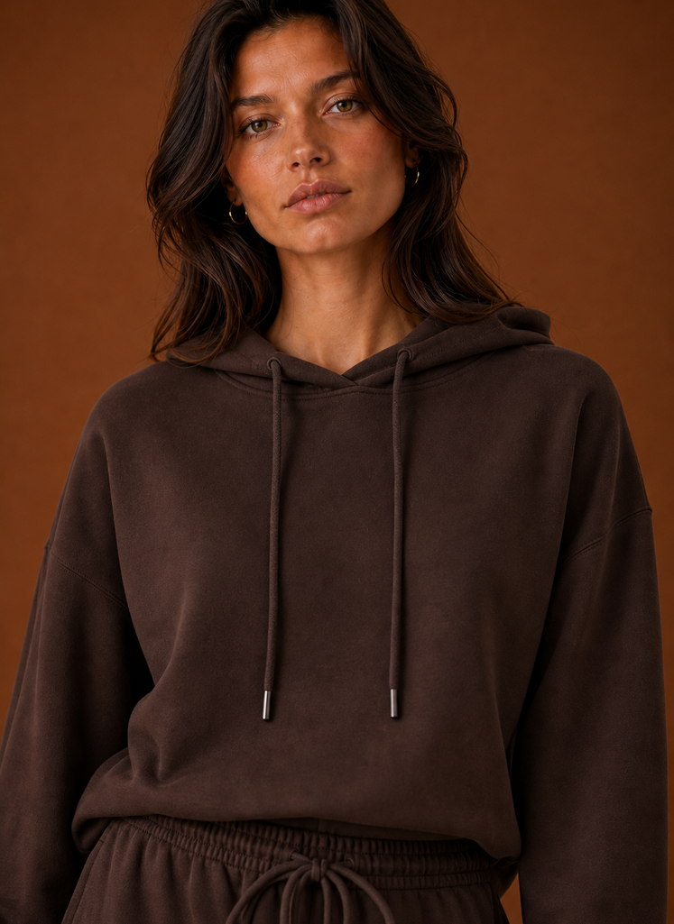 Close-up of the sweatsuit fabric and stitch detailing on the sweatshirt and pant waistband area