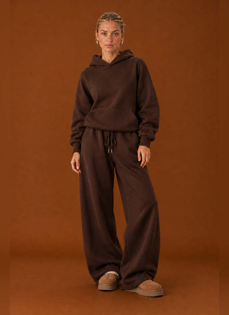 Front view of two-piece sweatsuit set showing sweater and pants on a model