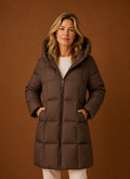 Front view of women's long hooded puffer coat on a mannequin