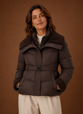 Front view of the women's belted puffer jacket on a plain background