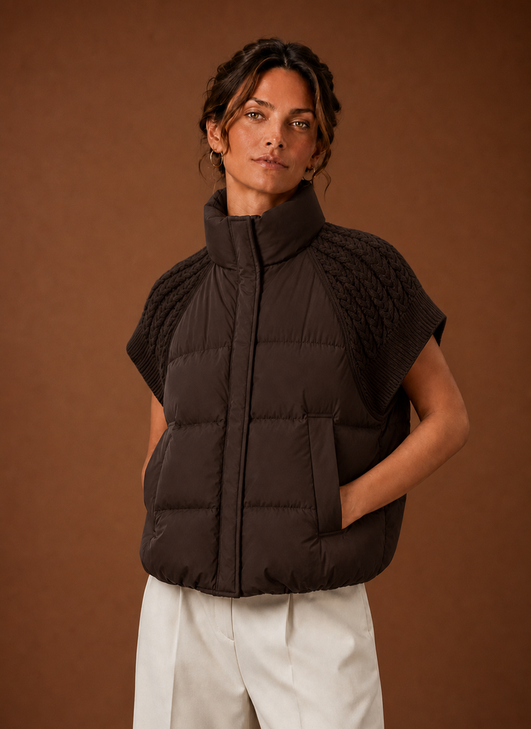 Front view of women's puffer vest with knit shoulder panels on a mannequin