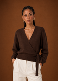 Front view of a women's cropped wrap sweater showing V-neck and tied waist