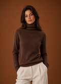 Front view of women's turtleneck sweater on neutral background