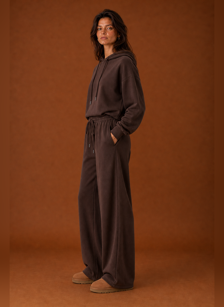 Side view of a women's sweatsuit highlighting the tracksuit silhouette and pant profile