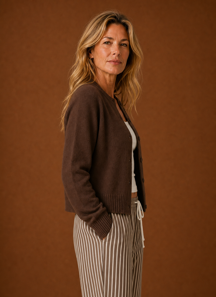 Side view of the women's crew neck cardigan showing the sleeve and button closure