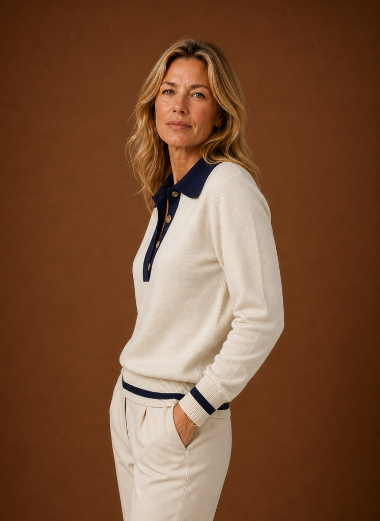 Side profile of the cream polo sweater showing sleeve silhouette and ribbed hem