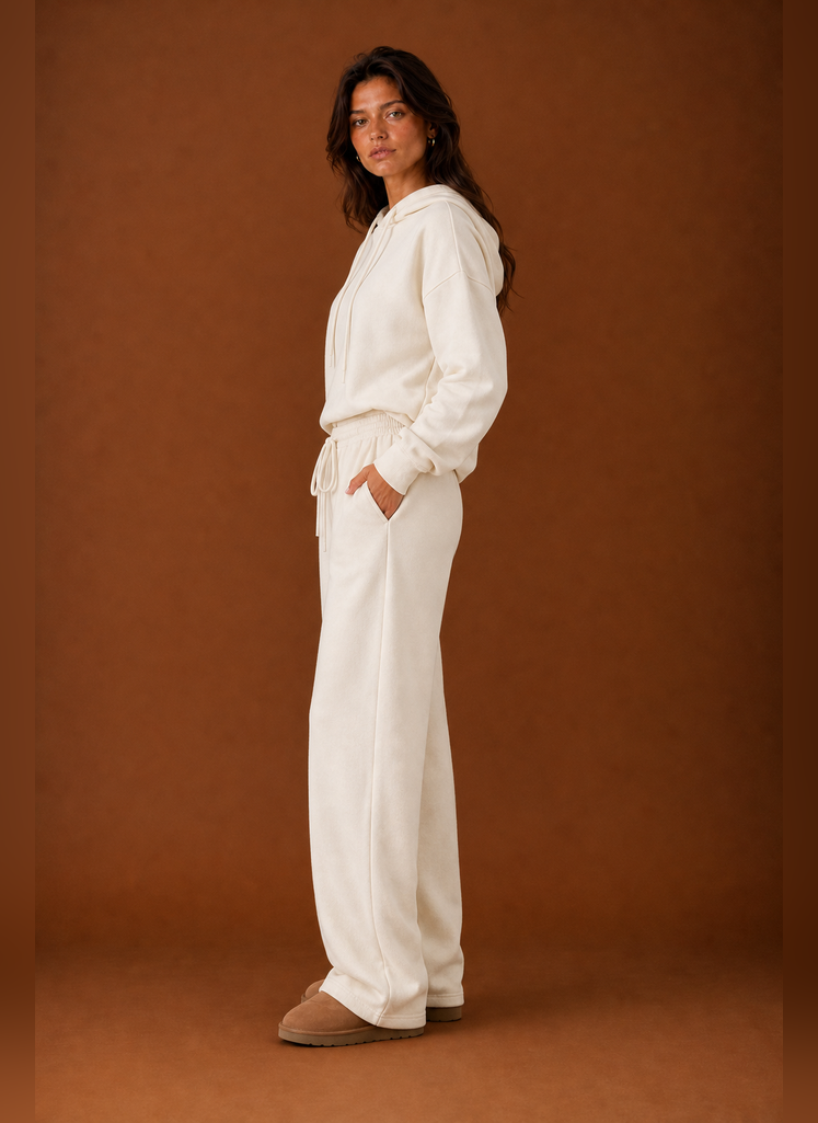 Side view of a women's sweatsuit highlighting the tracksuit silhouette and pant profile