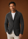 Front view of men's knit cardigan jacket with button-front closure on mannequin