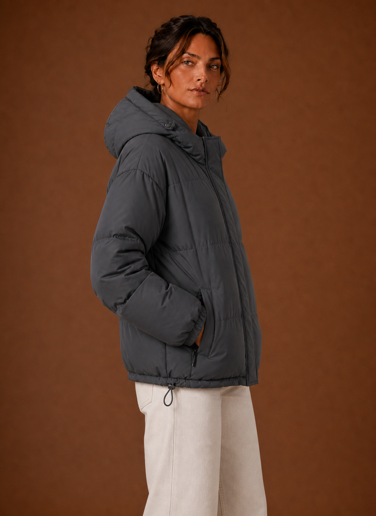 Side profile of the women's hooded puffer jacket showing sleeve and fit