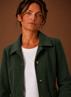 Close-up of the trench coat's button-front closure and front placket